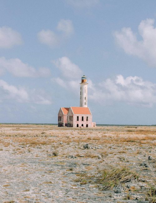 Explore the isolated beauty of an abandoned lighthouse on Klein Curacao, captured on a clear day.
